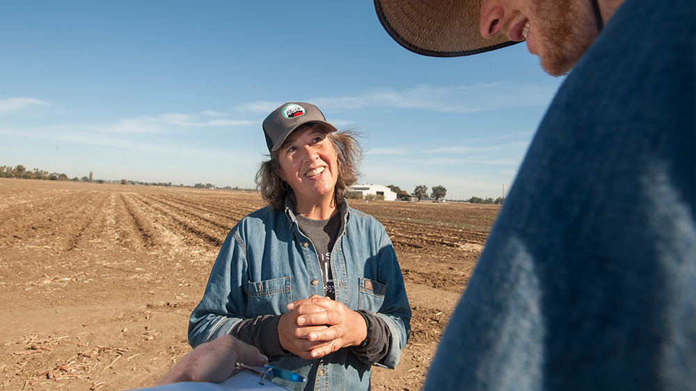 Professor Kate Scow talks with a student about soil health.