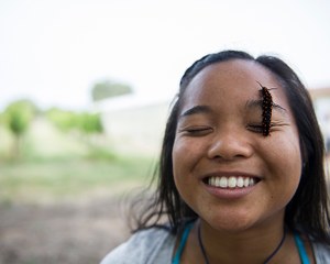 Girl with bug on her face smiling