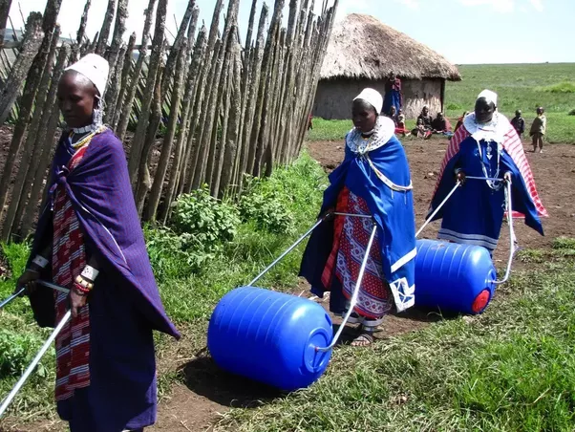 Women using barrels to haul water