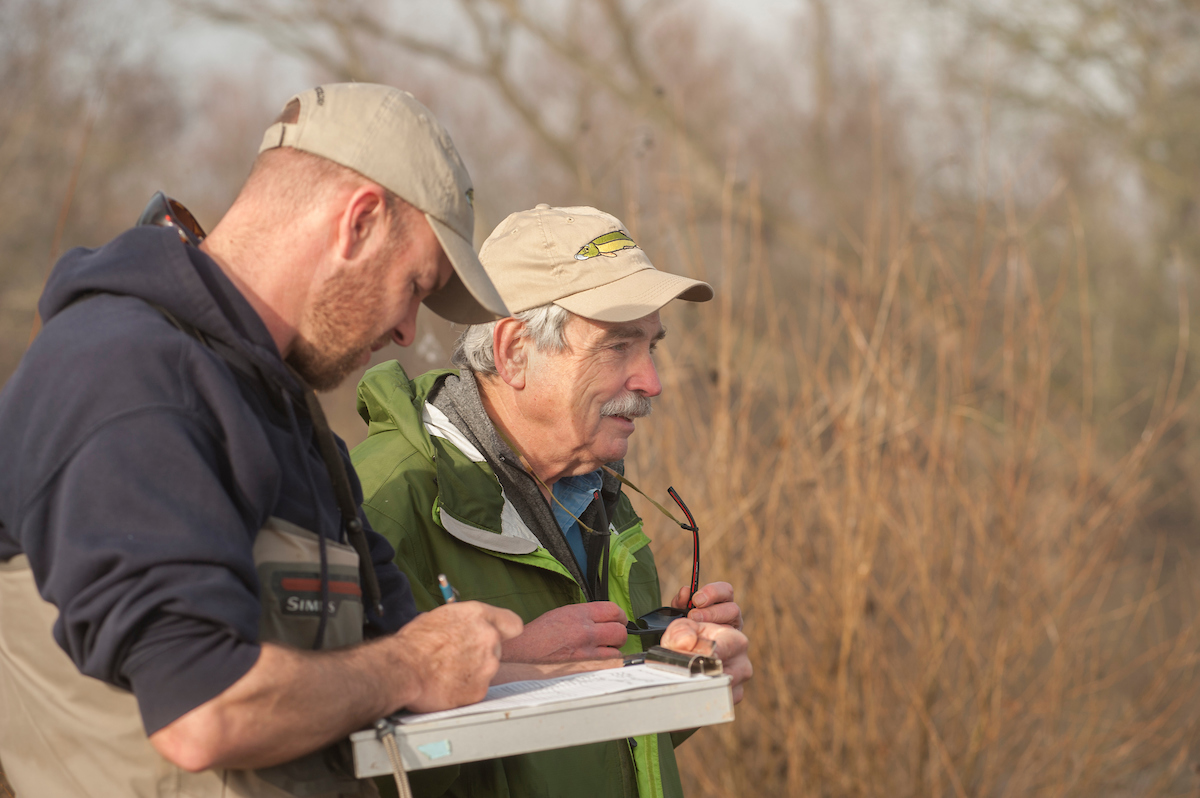 Carson Jeffres takes notes beside Peter Moyle during field work. (Gregory Urquiaga/UC Davis)