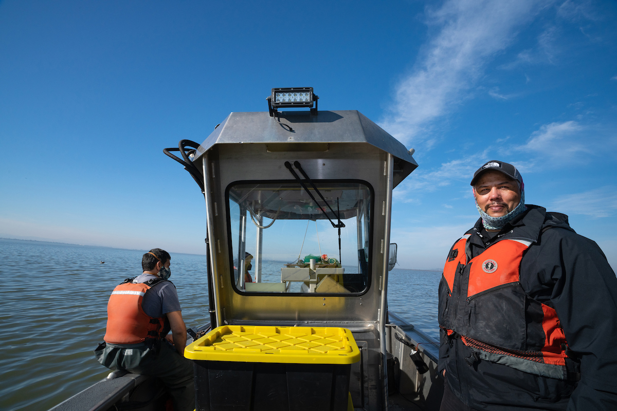 UC Davis fish ecologist Levi Lewis with field technician Micah Bisson aboard a research vessel while studying longfin smelt in 2022. (Alysha Beck/UC Davis)