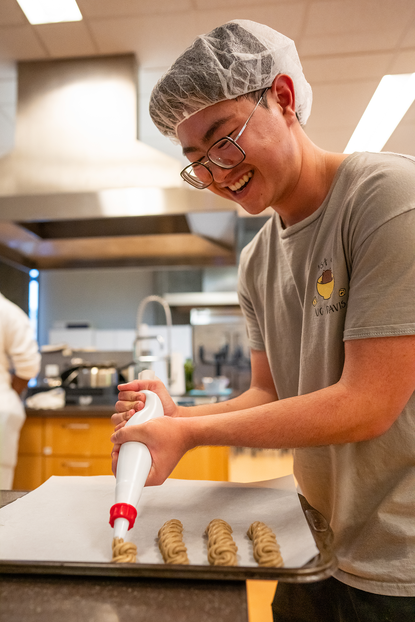 Scott Lo, senior majoring in food science and technology, cooking churros with his team. Photo by: Jael Mackendorf, UC Davis.
