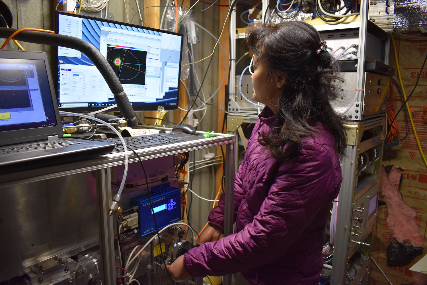 UC Davis Professor Qi Zhang tunes a laser vaporizer on the Soot Particle Aerosol Mass Spectrometer at Mount Bachelor Observatory to optimize detection for black carbon-containing particles. (Christopher Niedek/UC Davis)