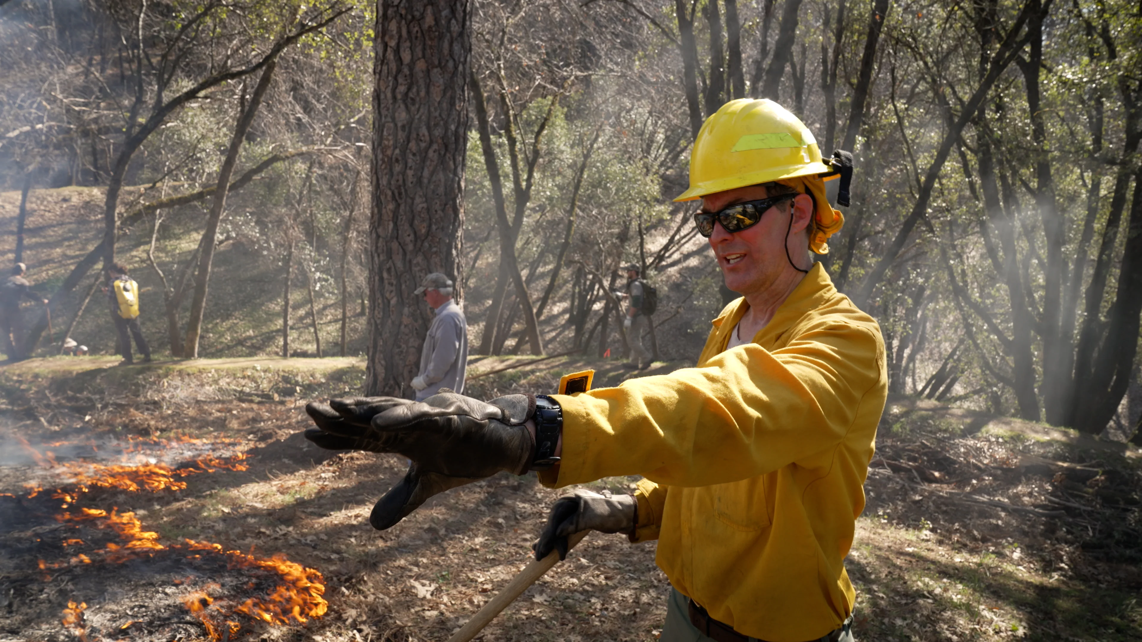 John Williams, a UC Davis project scientist, at a prescribed burn with a private landowner in Placerville, California in 2022. (Tim McConville/UC Davis)