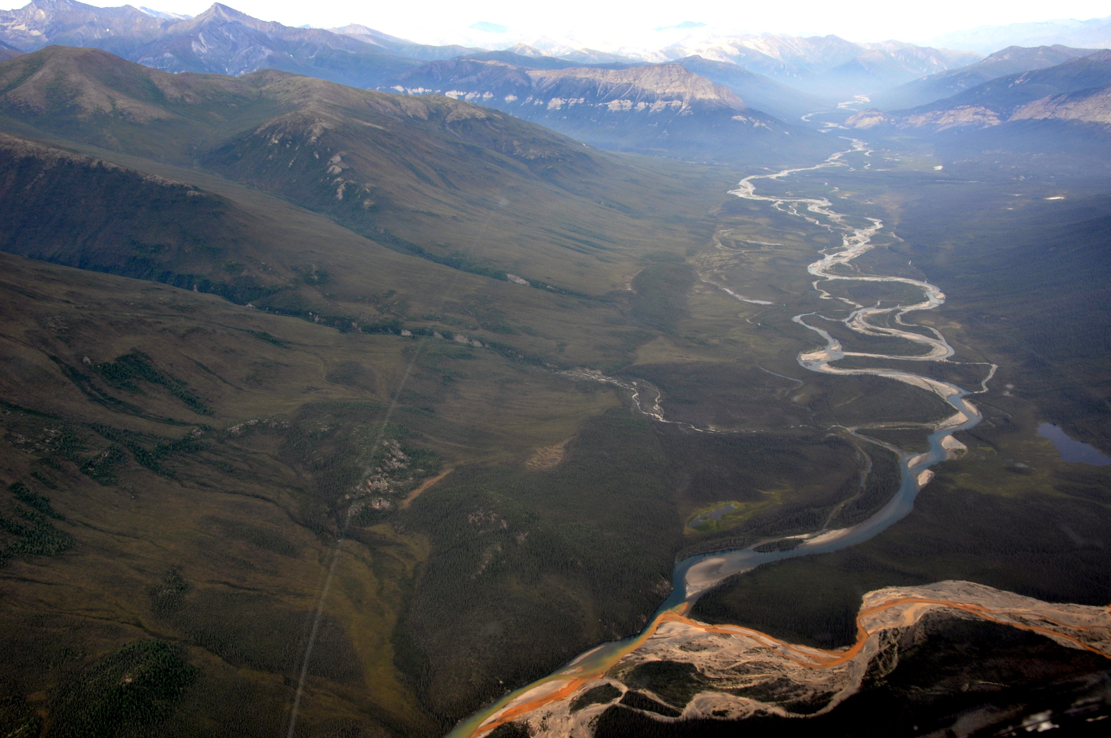 An aerial view of the Kutuk River in Alaska’s Gates of the Arctic National Park, where a portion of the water is rust-stained. (Ken Hill / National Park Service)
