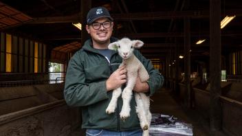 A student holding at lamp at the UC Davis Student Farm.