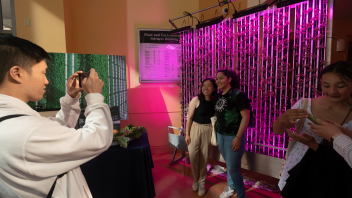 Student get photos with the vertical farming research h at Plant and Environmental Science Building during Picnic Day on April 15, 2023.