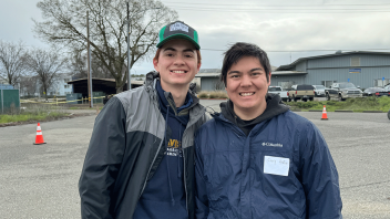 Two UC Davis students stand together outside on Field Day.