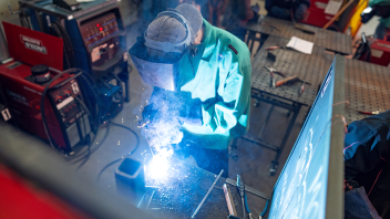 A student welds metal during a class in the Western Center for Agricultural Equipment building.
