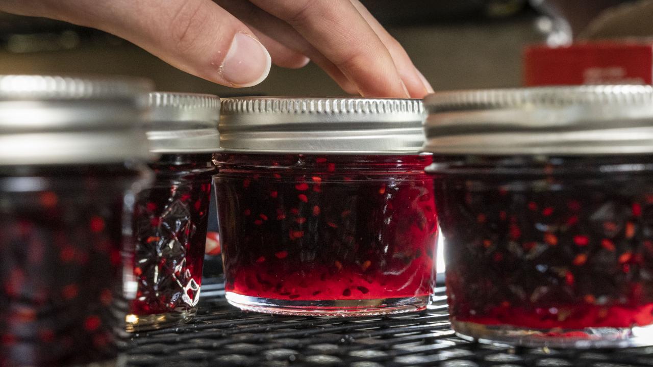 Fresh jelly is prepared in jars.