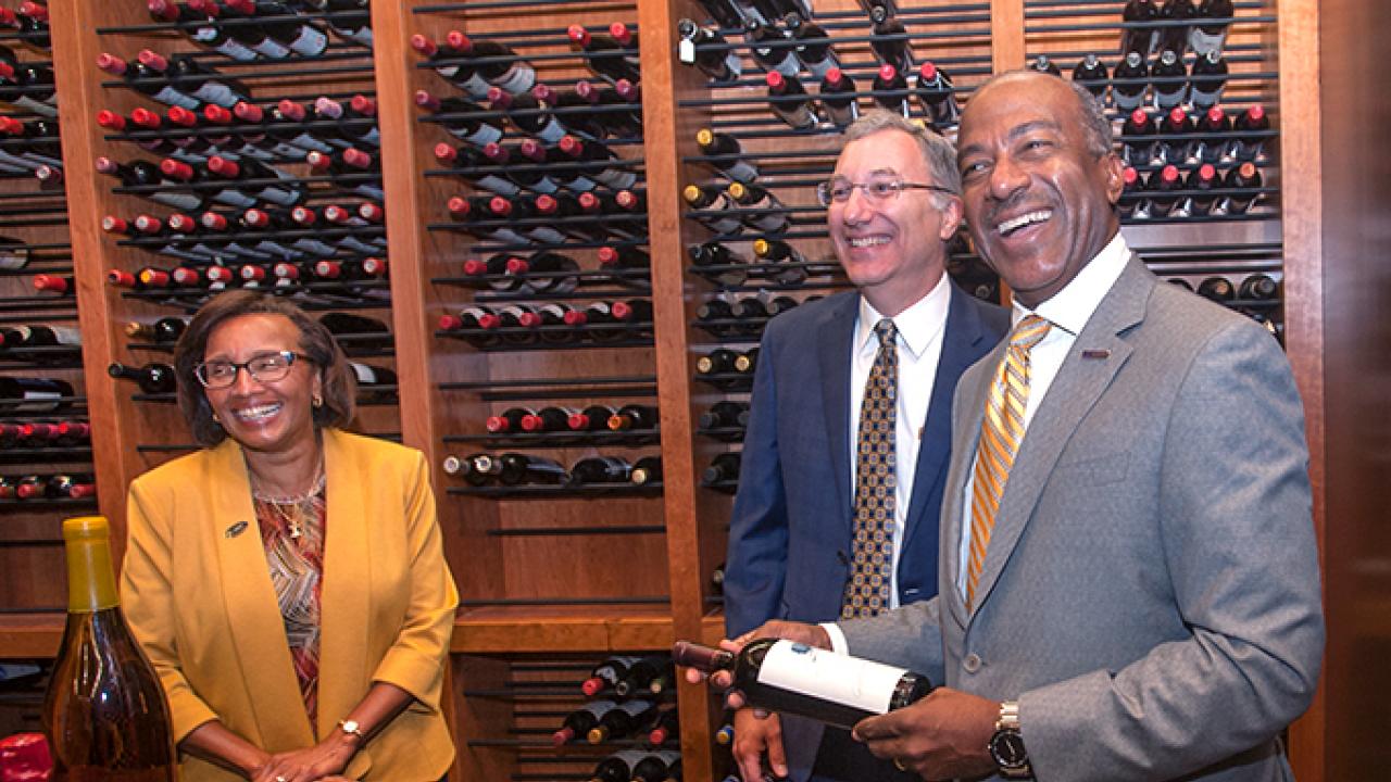 Viticulture and Enology Professor David Block (center) recently gave a tour of the campus winery to Dean Helene Dillard and UC Davis Chancellor Gary May.