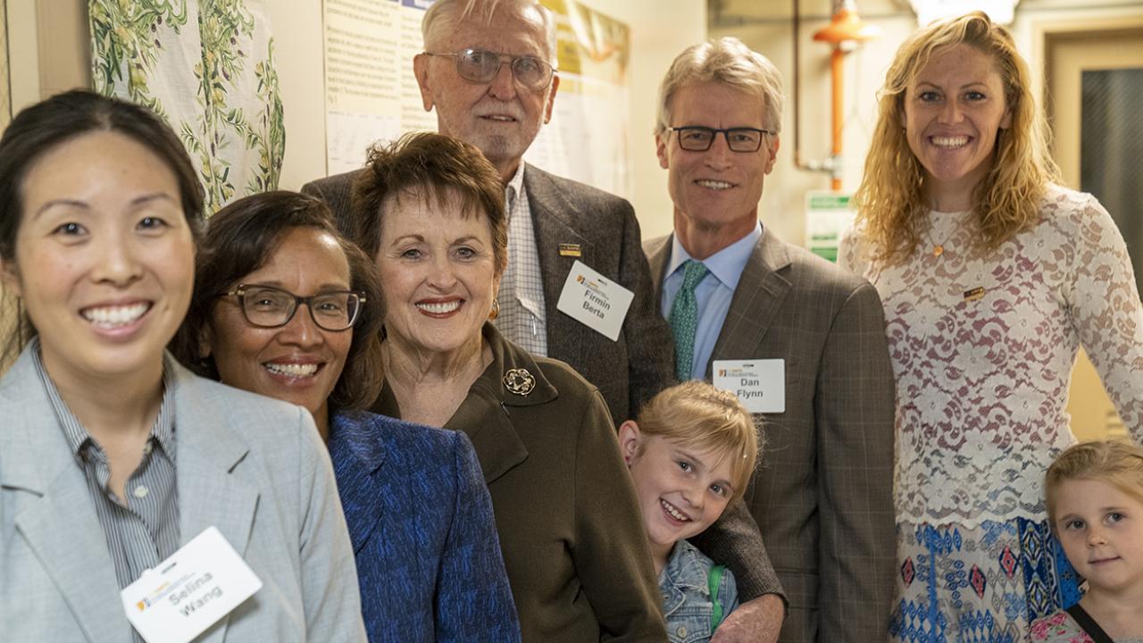 The Berta family, Olive Center staff and Dean Helene Dillard celebrate the dedication of a renovated lab in the Sprocket Building on November 15.