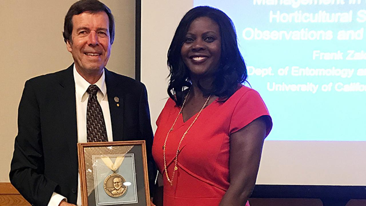 Distinguished entomology professor Frank Zalom receives the 2017 Morrison Medal from Chavonda Jacobs-Young, the USDA-ARS administrator, at a September ceremony in Hawaii.