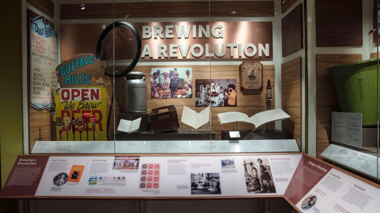 New showcase in the National Museum of American History features UC Davis Professor Emeritus Michael Lewis on a placard, lower right, and his “well-used and beat-up” textbook in the display. (National Museum of American History)