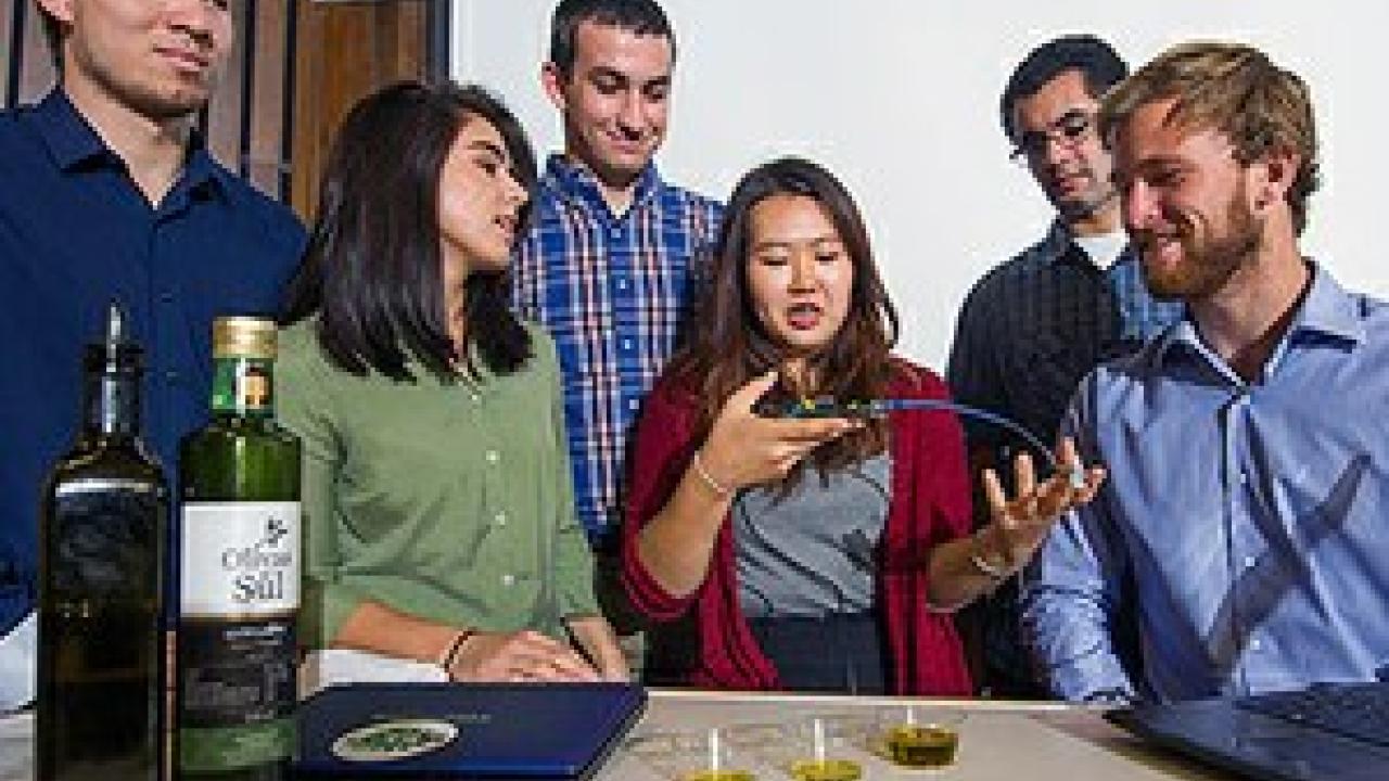 A team of UC Davis students built a bio-sensor machine that can detect rancid or fraudulent olive oil. From left are: James Lucas, Sarah Ritz, Simon Staley, Yeonju Song, Brian Tamsut and Lucas Murray. (Karin Higgins/UC Davis)
