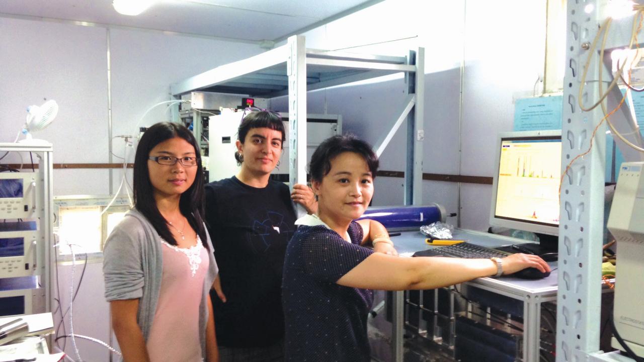 Qi Zhang (right) operates an aerosol mass spectrometer with Ph.D. student Shan Zhou (left) and project scientist Sonya Collier (center) during 2014 field study in Nanjing, China.