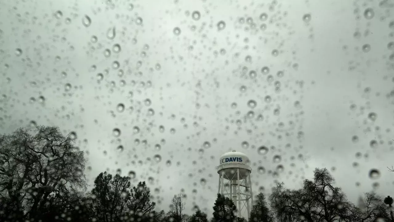 The UC Davis water tower as seen through a rain-splattered window during storms in January 2023. (Gregory Urquiaga, UC Davis)