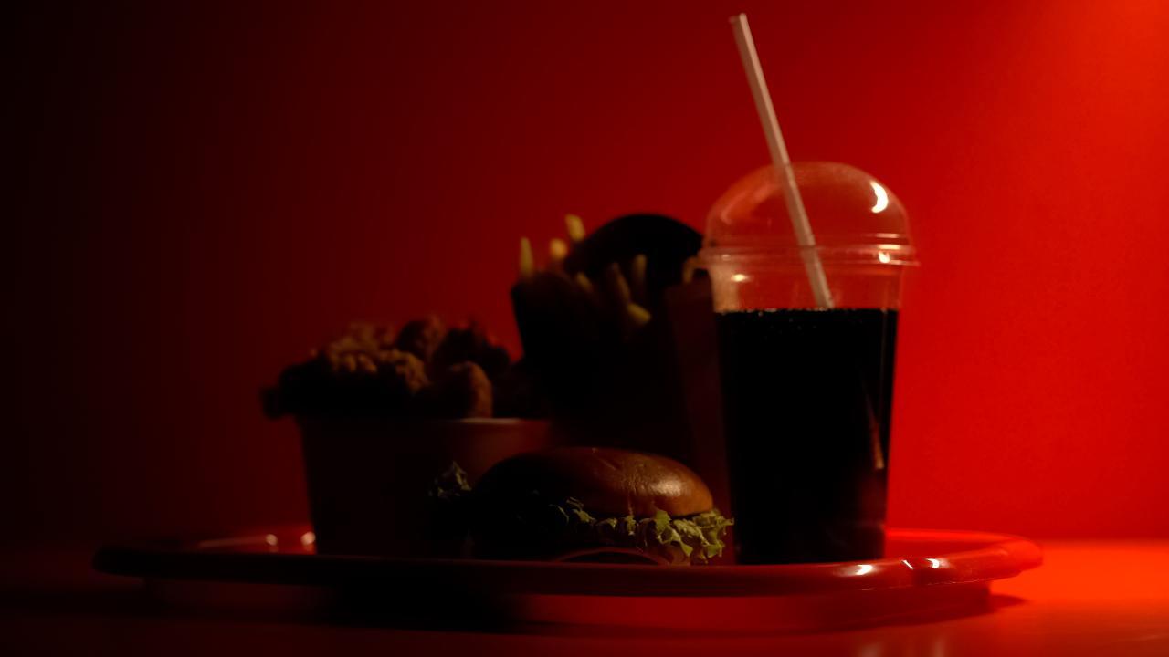 A collection of fast food items in front of a red background.