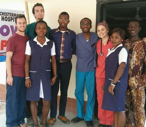 Alex Volzer (far left) outside of the Kristina Chesterman Memorial Clinic in Ozu Abam, Nigeria