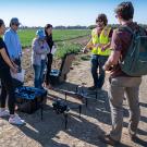 Students learning to use a drone in the "Introduction to Unmanned Aerial Systems for Agriculture and Environmental Science" class last year.