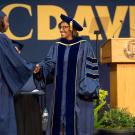 Helene Dillard shaking a newly graduated student's hand at the UC Davis CA&ES commencement.