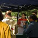 Dean Helene Dillard visits nutrition students at their booth at the UC Davis Farmers Market. (Jason Spyres/UC Davis)