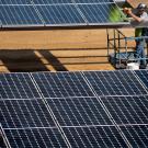 Workers install the parking lot solar panels at West Village at UC Davis in Davis, CA.