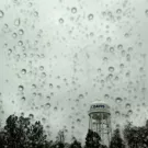 The UC Davis water tower as seen through a rain-splattered window during storms in January 2023. (Gregory Urquiaga, UC Davis)