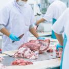 Butcher cutting meat.