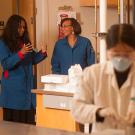 Dean Helene Dillard and professor Dianne Beckles talk as students work during a genetics and biotech lab class.