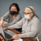 Elaine Li, student, works with older adult Ninette Lawrence in a UC Davis class that pairs students with seniors at the Davis Senior Center. (Jael Mackendorf/UC Davis)