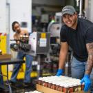 Moises Gomez of the winning Iron Brew team assists with packaging Mighty Gale Ale at Sudwerk Brewing Co. (Joel Mackendorf/UC Davis)