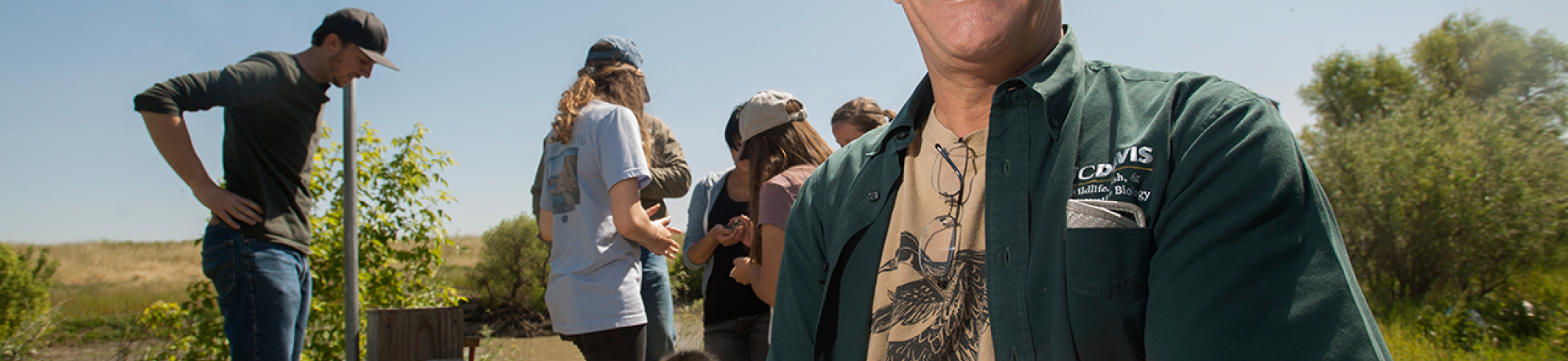 Professor John Eadie holds a duckling while collecting data for his wood duck research.